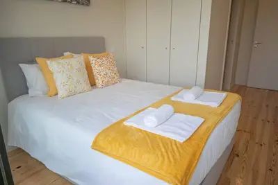 a large white bed with towels on top of it at Truly Porto in Porto