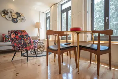 a living room with a table and chairs at Truly Porto in Porto