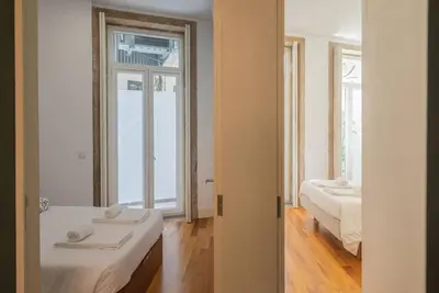 a room with two beds and a window at So Truly Porto in Porto