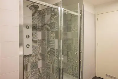 a shower with a glass door in a bathroom at So Truly Porto in Porto