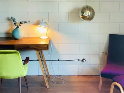 a room with a desk with a lamp and two chairs at Fabrica No Jardim in Porto