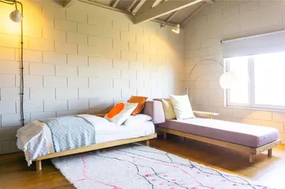 a bedroom with two beds and a rug at Fabrica No Jardim in Porto