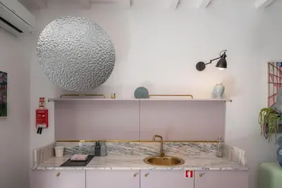 a kitchen with a sink and a large orb on the wall at Gracy Porto in Porto