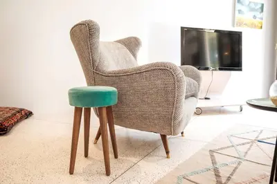 a chair and a stool in a living room at Gracy Porto in Porto