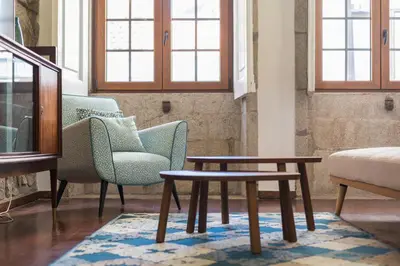 a living room with two chairs and a table at Mercadory Ribeira in Porto