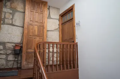 an entrance to a room with a wooden door at Mercadory Ribeira in Porto