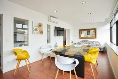 a dining room with yellow chairs and a table at So Family Porto in Porto