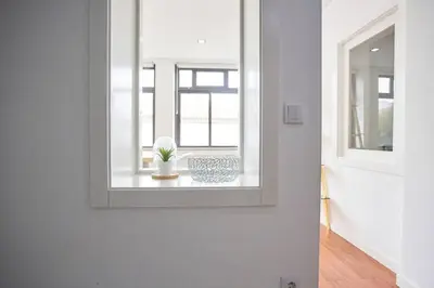 a mirror on a wall in a room with a table at So Family Porto in Porto