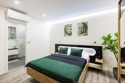 a dining room with a table and a clock on a wall at Porto City Holidays by Douro River in Porto