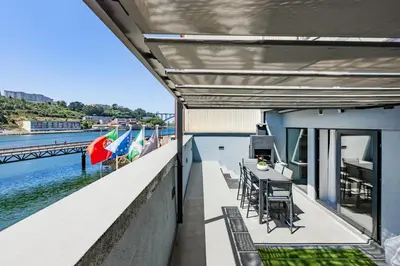 a kitchen with white walls and a stainless steel stove at Porto City Holidays by Douro River in Porto