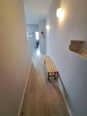 a hallway with a wooden bench in a room at Bolhão Apartment in Porto