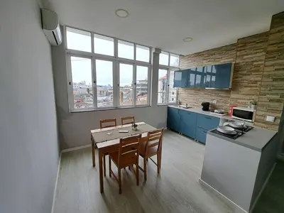 a kitchen with a table and chairs in a room at Bolhão Apartment in Porto