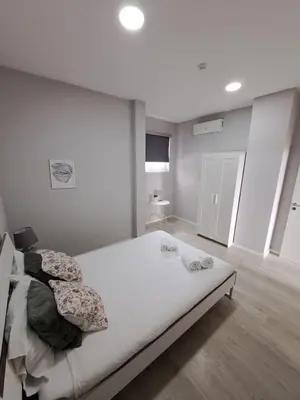 a bedroom with a large bed with pillows on it at Bolhão Apartment in Porto