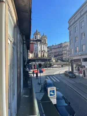 a building with a parking sign on the side of a street at Estúdio Histórico século XIX com Varanda e Vistas para a Baixa in Porto