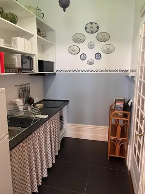 a kitchen with plates on the wall and a counter at Estúdio Histórico século XIX com Varanda e Vistas para a Baixa in Porto