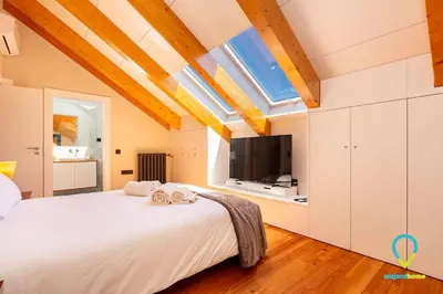 a bedroom with a large bed and a tv at So Trendy Porto in Porto