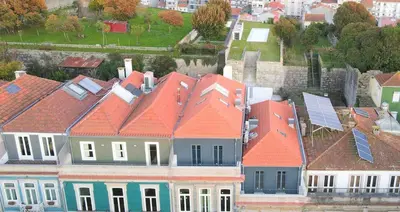 a bedroom with a large white bed with white pillows at Terrace Pool Apartment Oporto by LovelyStay in Porto