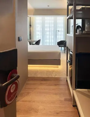 a row of beds in a waiting room with a lamp at Bom Sucesso Hotel by gaiarooms in Porto