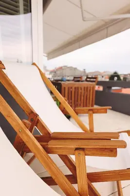 a couple of chairs sitting on a porch at Boavista Sunlit Duplex with Terrace in Porto