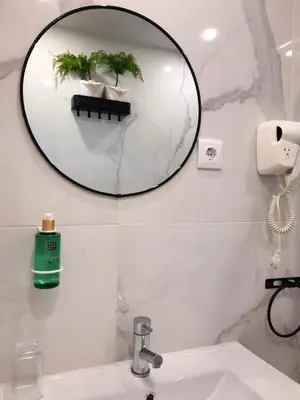 a bathroom with a mirror above a sink at Smiling Places - Apartment in Porto in Porto