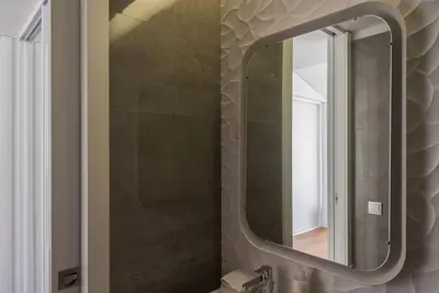 a bathroom with a mirror and a sink at Comfy Porto in Porto