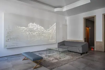 a living room with a couch and a glass table at Comfy Porto in Porto