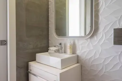 a bathroom with a sink and a mirror at Comfy Porto in Porto