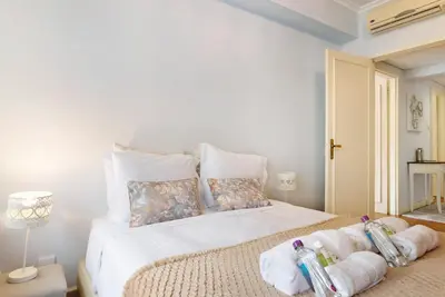 a bedroom with a white bed with towels on it at Apartment Boutique Santa Catarina 1 in Porto