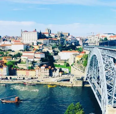 a bridge over a river with a city in the background at Apartment Boutique Santa Catarina 1 in Porto