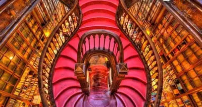 a view of a red spiral staircase with books at Apartment Boutique Santa Catarina 1 in Porto