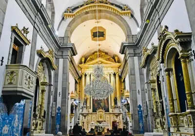 a church with a chandelier hanging from the ceiling at Apartment Boutique Santa Catarina 1 in Porto
