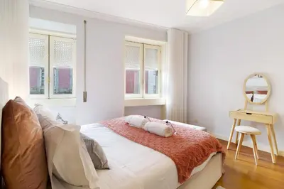 a bedroom with a bed with two towels on it at Apartment Boutique Santa Catarina 1 in Porto