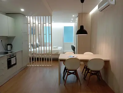 a kitchen and dining room with a table and chairs at 714 Galé Apartment Wi-Fi in Porto