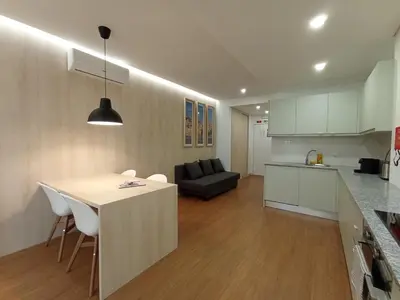 a kitchen and living room with a table and a couch at 714 Galé Apartment Wi-Fi in Porto