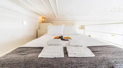 a bedroom with a bed with a tray of food on it at Boavista Loft by LovelyStay in Porto