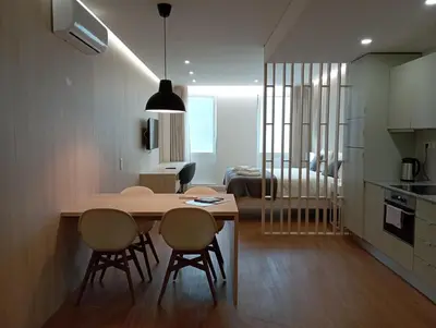 a kitchen and dining room with a table and chairs at 715 Galé Apartment Wi-Fi, Estacionamento in Porto