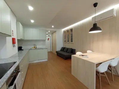 a kitchen and living room with a table and a couch at 715 Galé Apartment Wi-Fi, Estacionamento in Porto