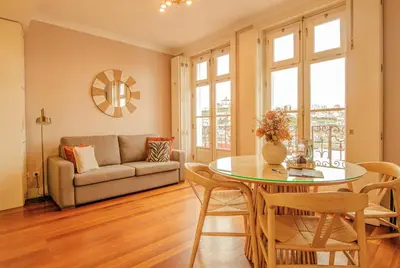 a living room with a table and a couch at RIBEIRA by YoursPorto in Porto