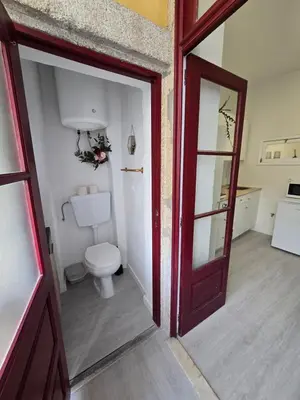 an open door to a bathroom with a toilet at River Flat III - Heart of Porto in Porto
