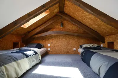 two beds in a room with a roof at Welcome to my city in Porto