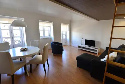 a living room with a table and a couch and a dining room at Welcome to my city in Porto