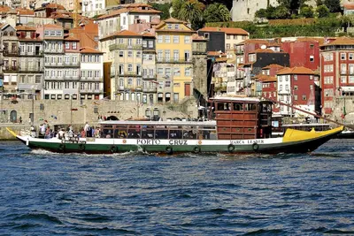 a boat in the water in front of a city at Welcome to my city in Porto