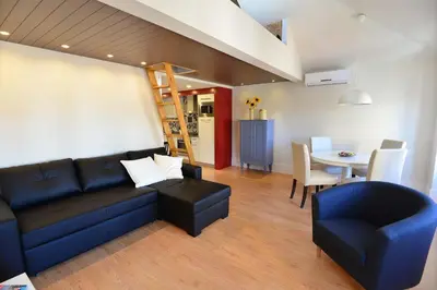 a living room with a blue couch and a table at Welcome to my city in Porto