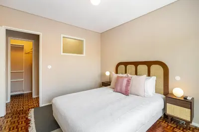 a bedroom with a large bed with white sheets and pink pillows at WHome SC996 in Top Location 3-Bed Perfect to explore Porto in Porto