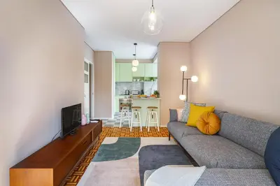 a living room with a couch and a tv at WHome SC996 in Top Location 3-Bed Perfect to explore Porto in Porto