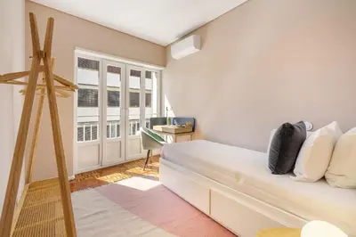 a bedroom with a bed and a window at WHome SC996 in Top Location 3-Bed Perfect to explore Porto in Porto