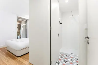 a white bathroom with a shower and a bed at Porto Calm Terrace Apartment in Porto