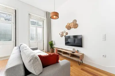 a living room with a couch and a tv at Porto Calm Terrace Apartment in Porto
