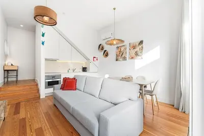a white living room with a couch and a table at Porto Calm Terrace Apartment in Porto