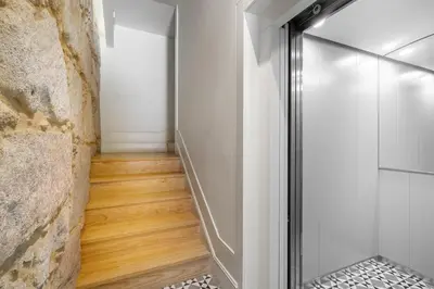 a glass shower door in a room with a wooden floor at WHome Timeless Luxury Porto w/ AC & Elevator in Porto